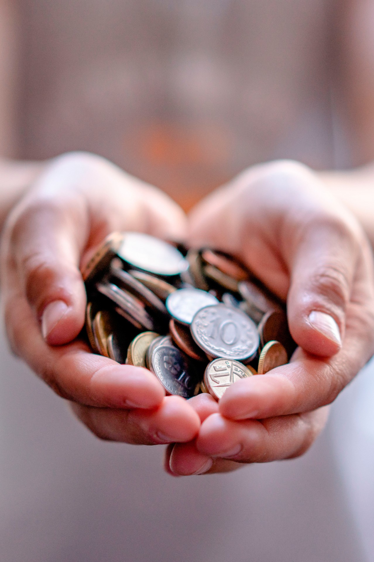 Cropped view of hands holding coins