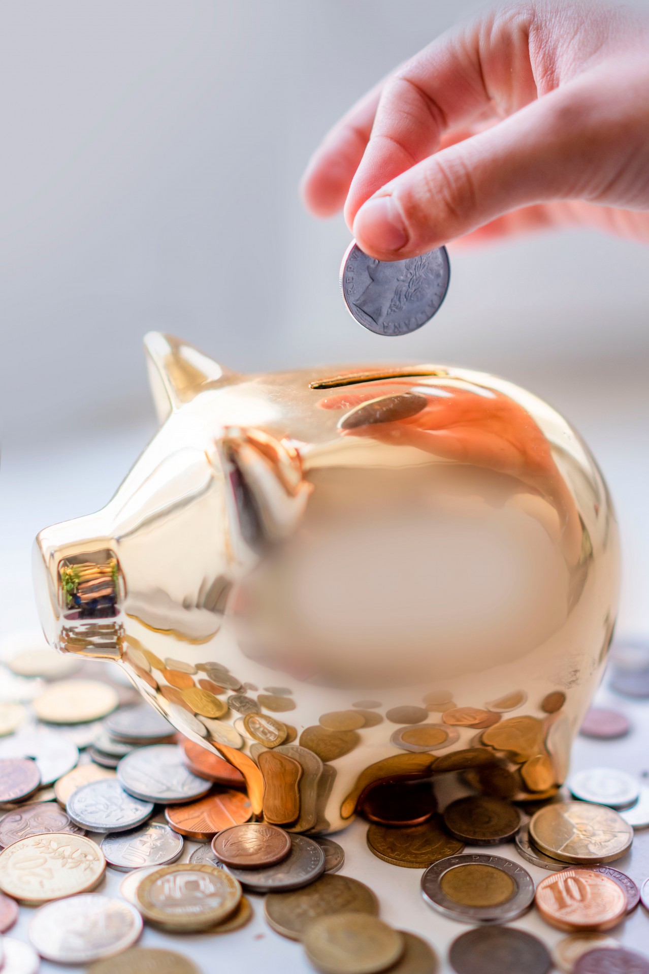 Person putting coin in the piggybank