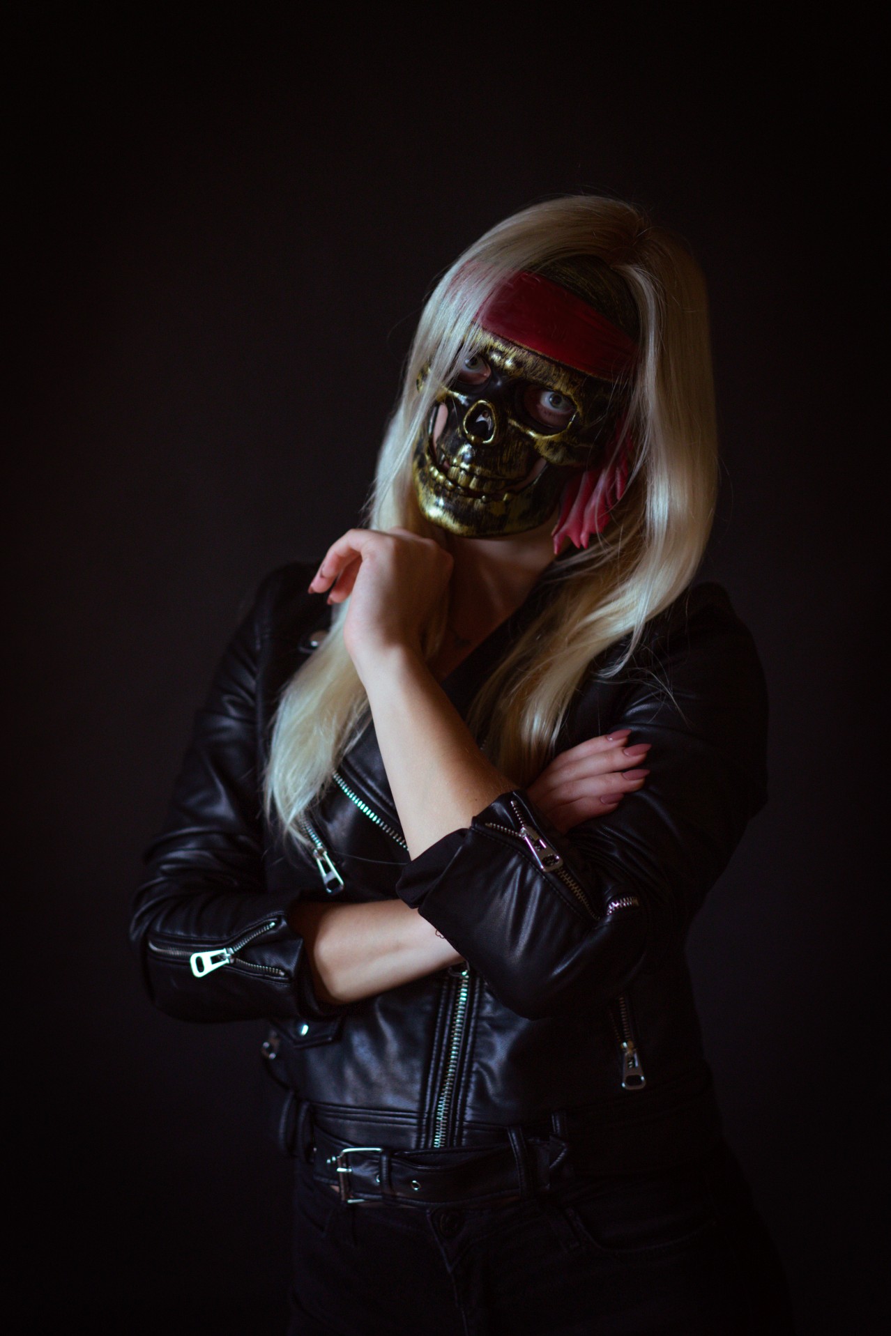 Girl in leather jacket and skull mask