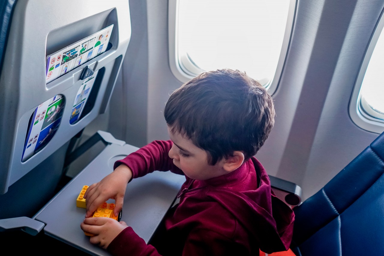 Kid plays with toy bricks during the flight