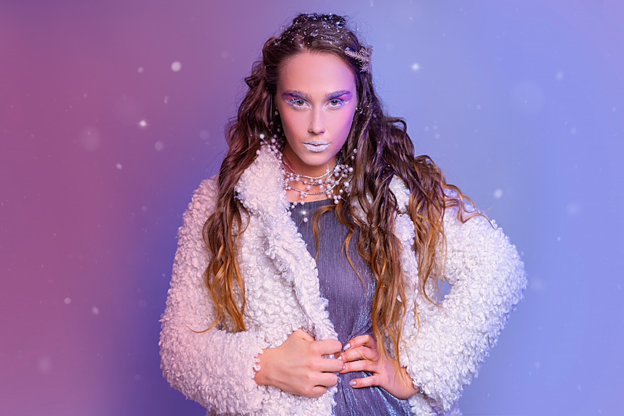 Stylish girl with shiny makeup posing in coat jacket
