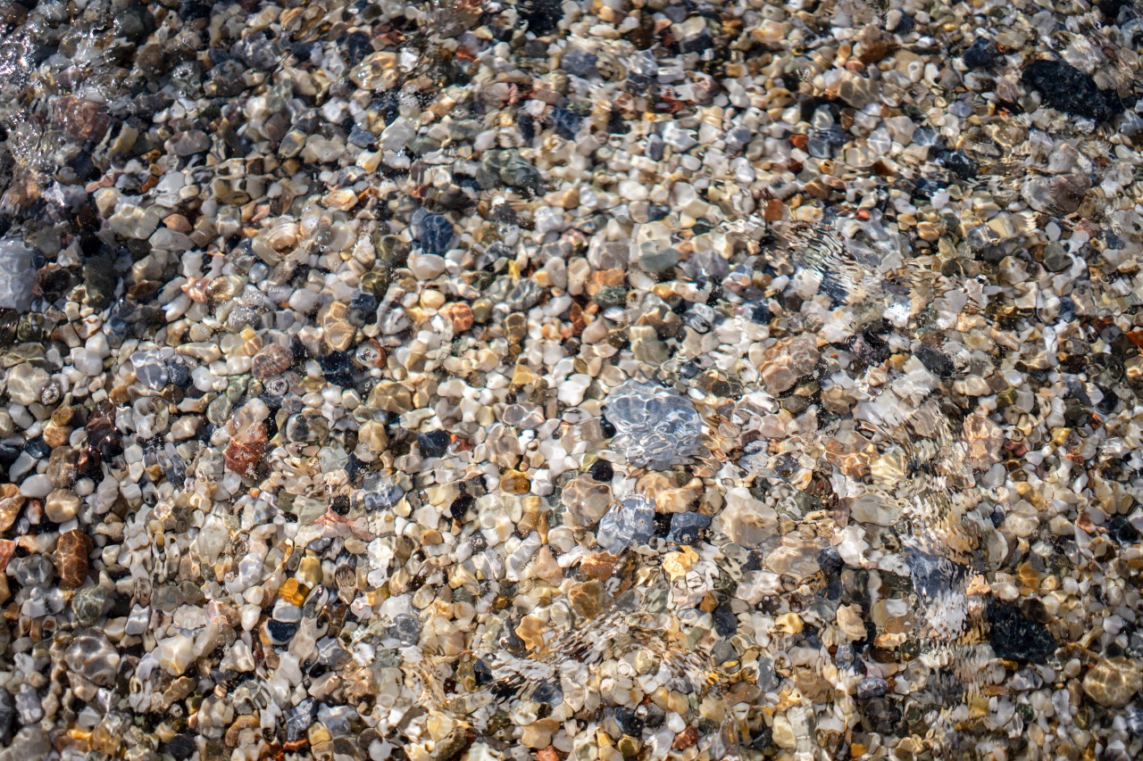 Colorful sea pebbles under water