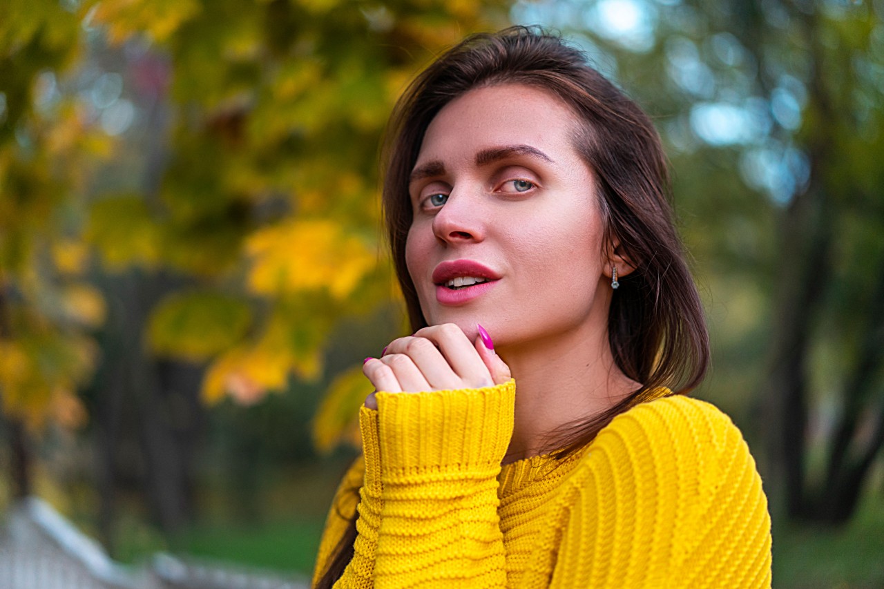 Young Brunette Woman in a Yellow Knitted Sweater 