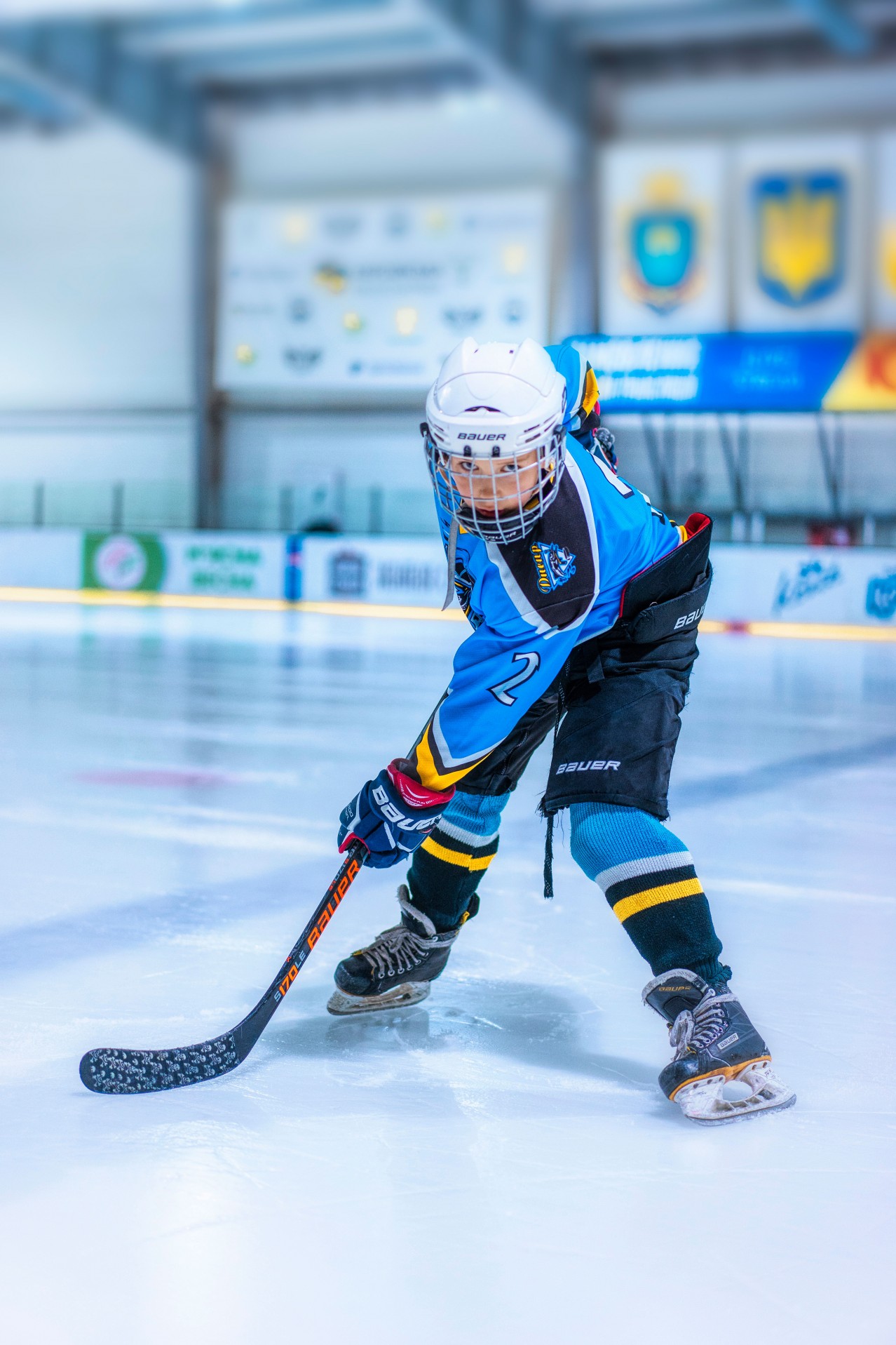 Young Hockey Player in Protective Clothes