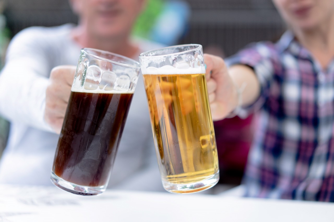 Blurred photo of people holding beer glasses