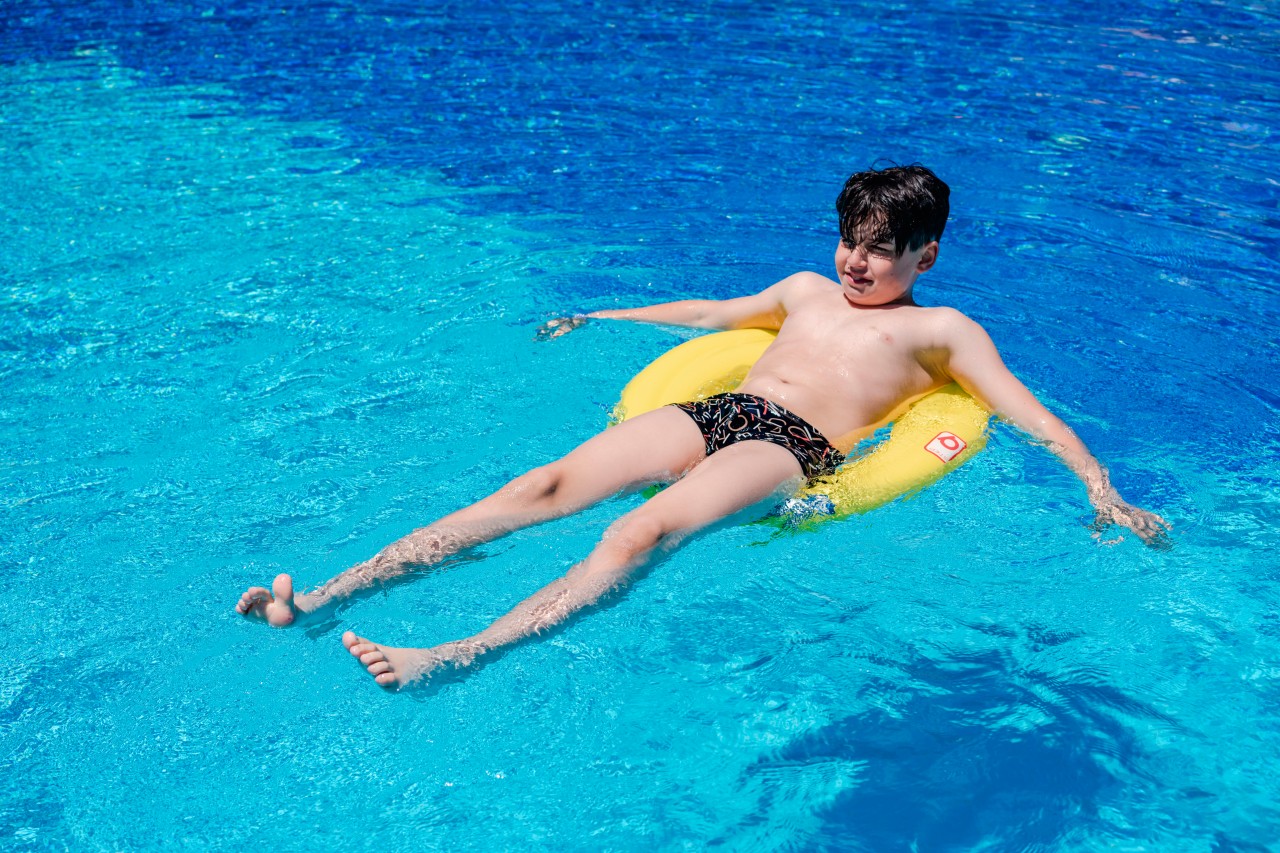 Boy with swim ring in the pool