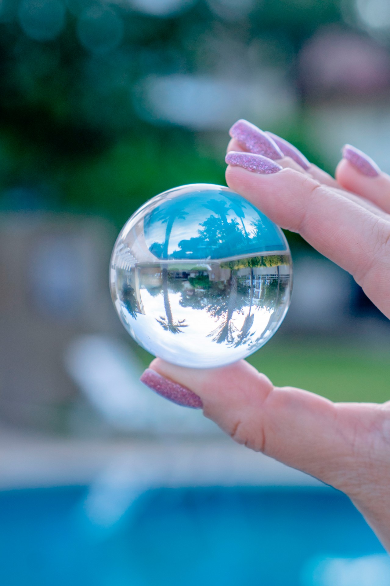 Woman holds crystal ball on a blurred background