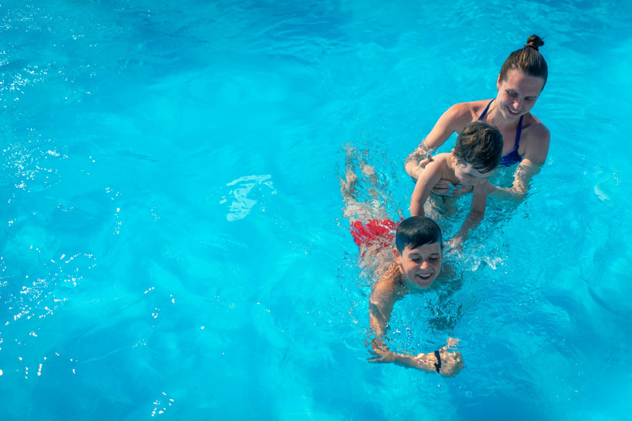 Family Have Fun in the Pool in Summer 