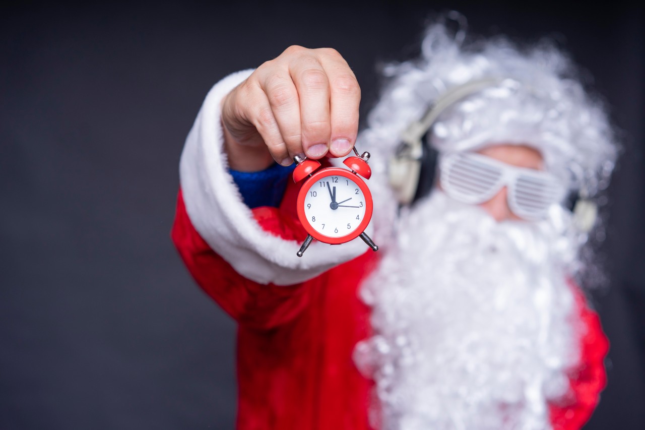 Santa Claus holds New Year clock