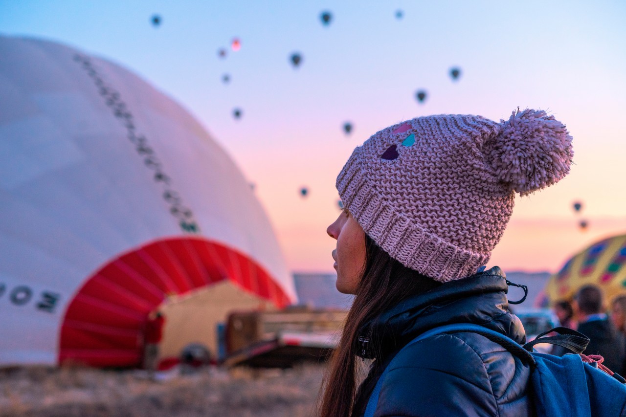Woman in hat at the balloon show in Cappadocia