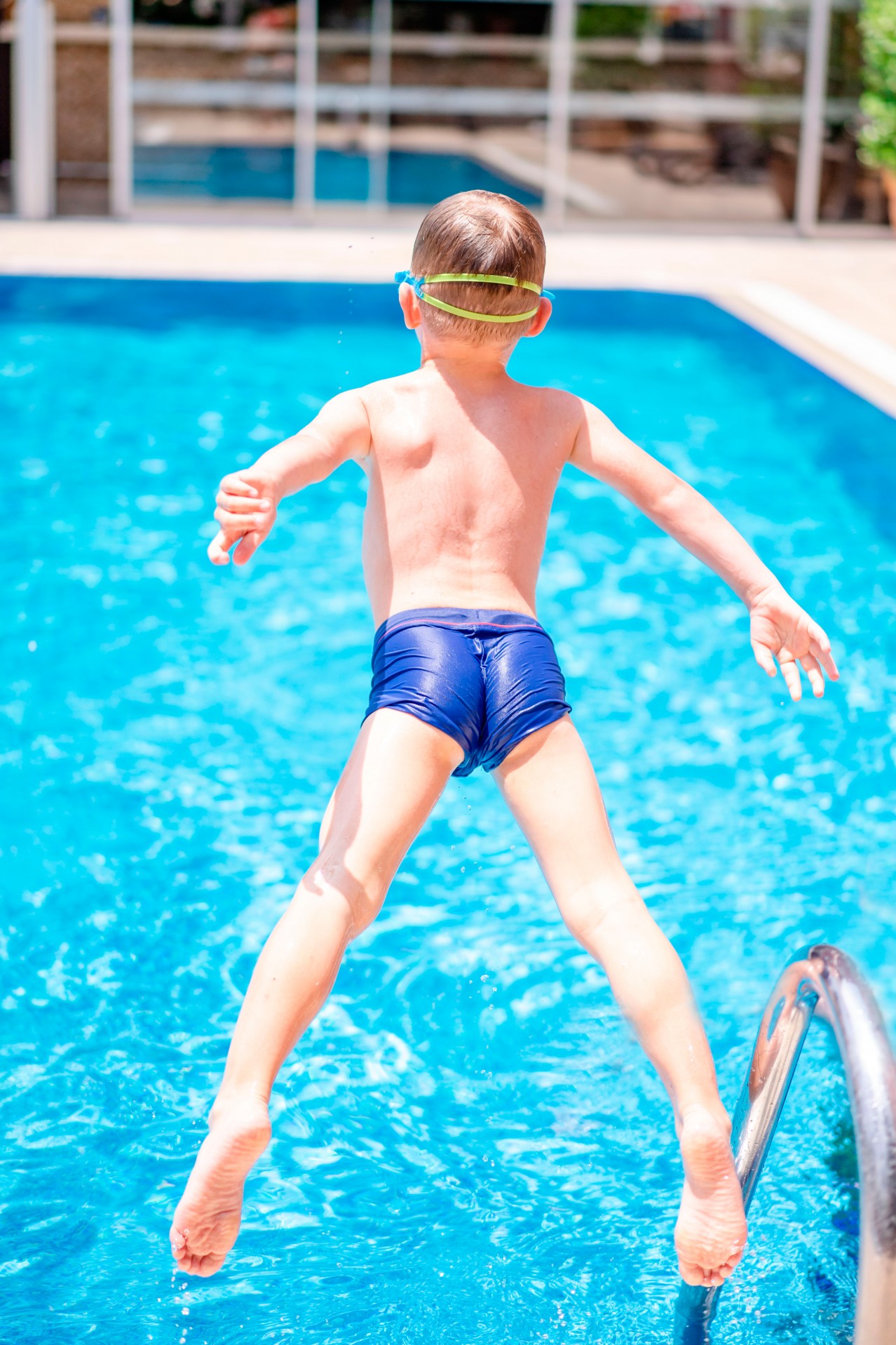Boy jumping in the swimming pool