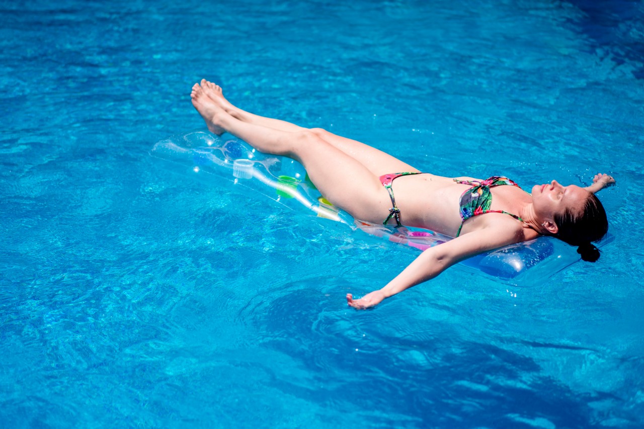 Woman in bikini on a swimming mattress