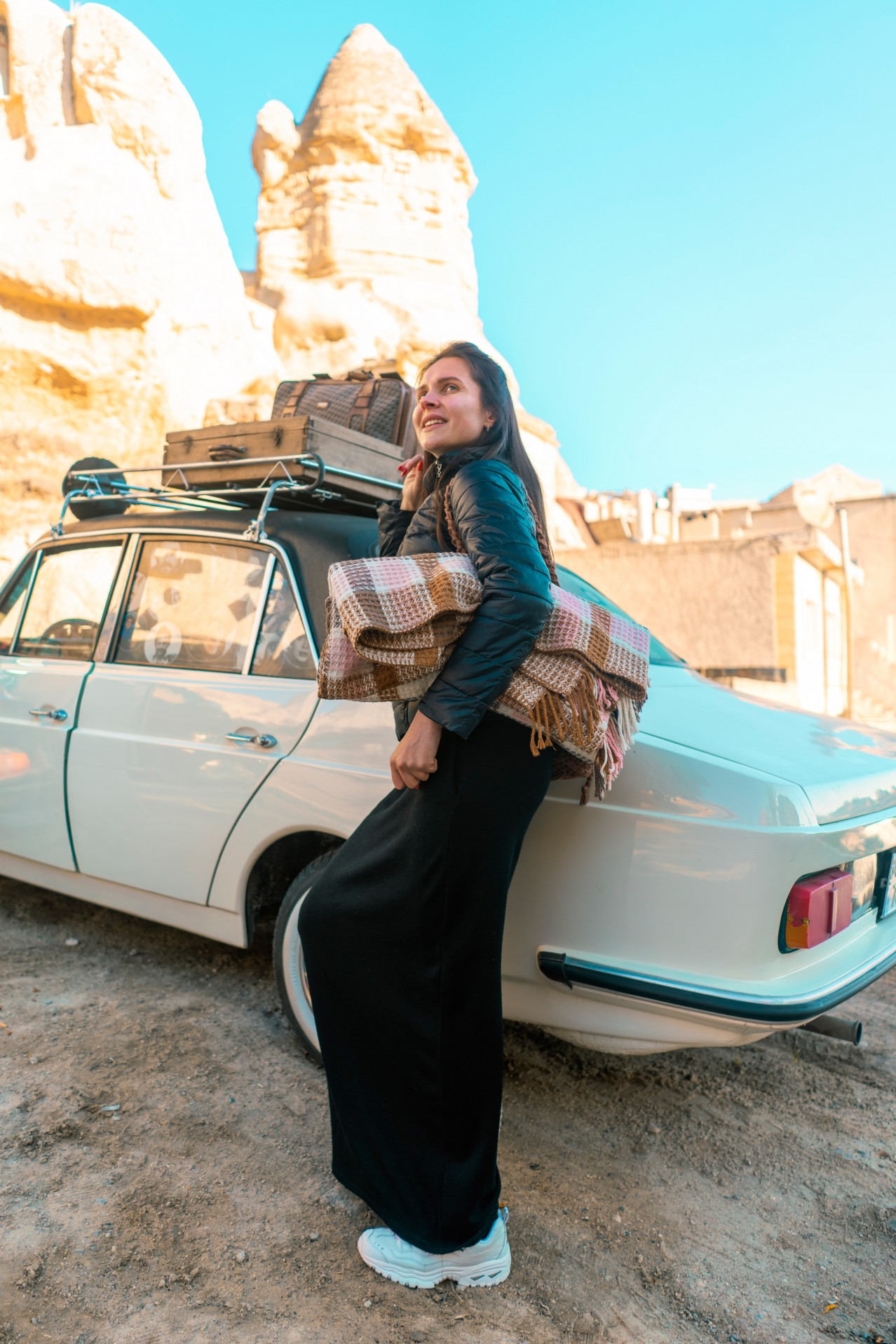 Excited woman with blanket during travel around Turkey