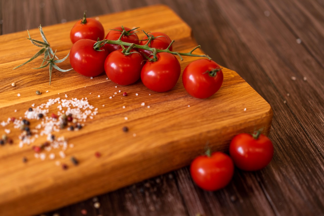 Ripe Cherry Tomatoes on a Wooden Background
