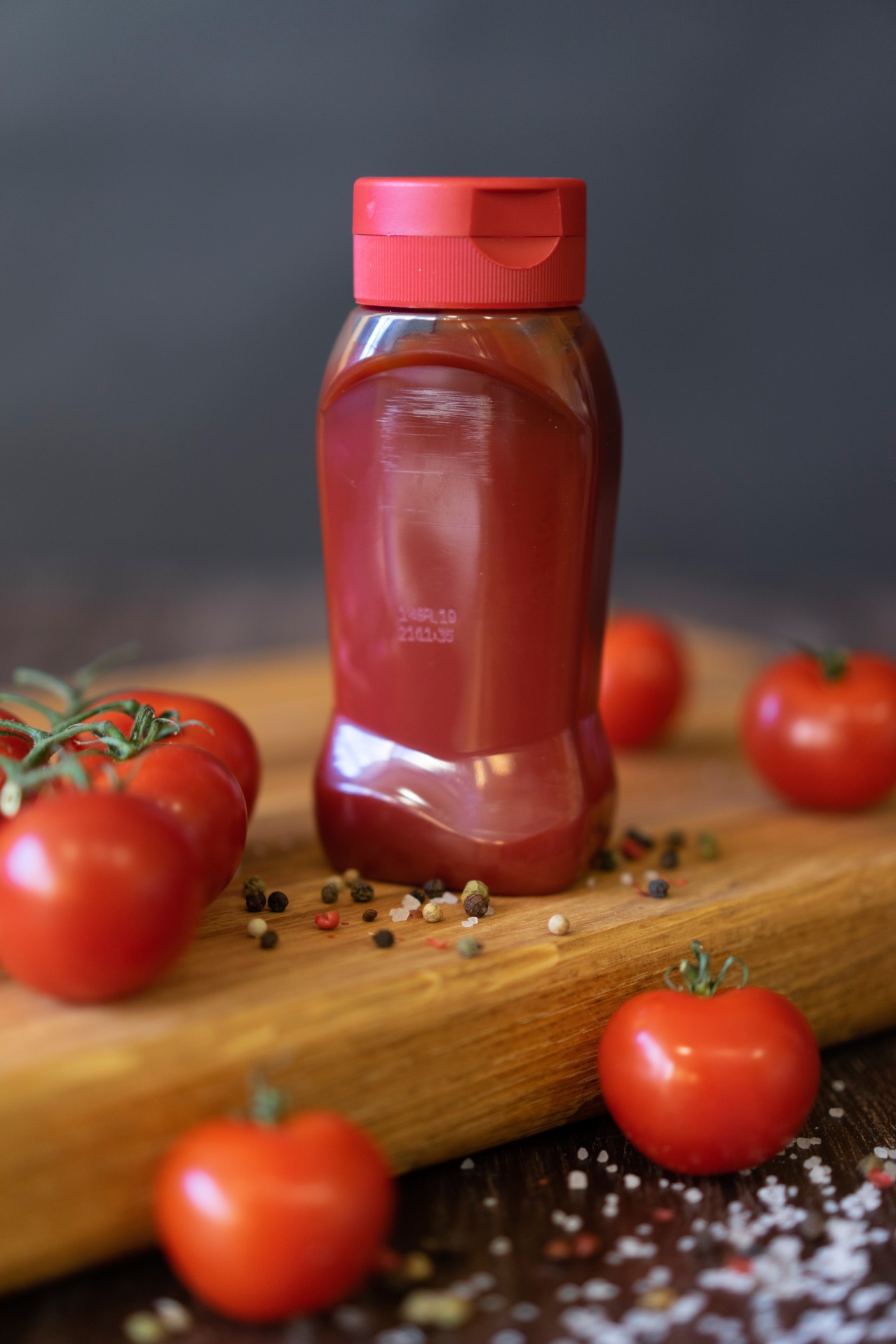 Red ketchup bottle on the cutting board