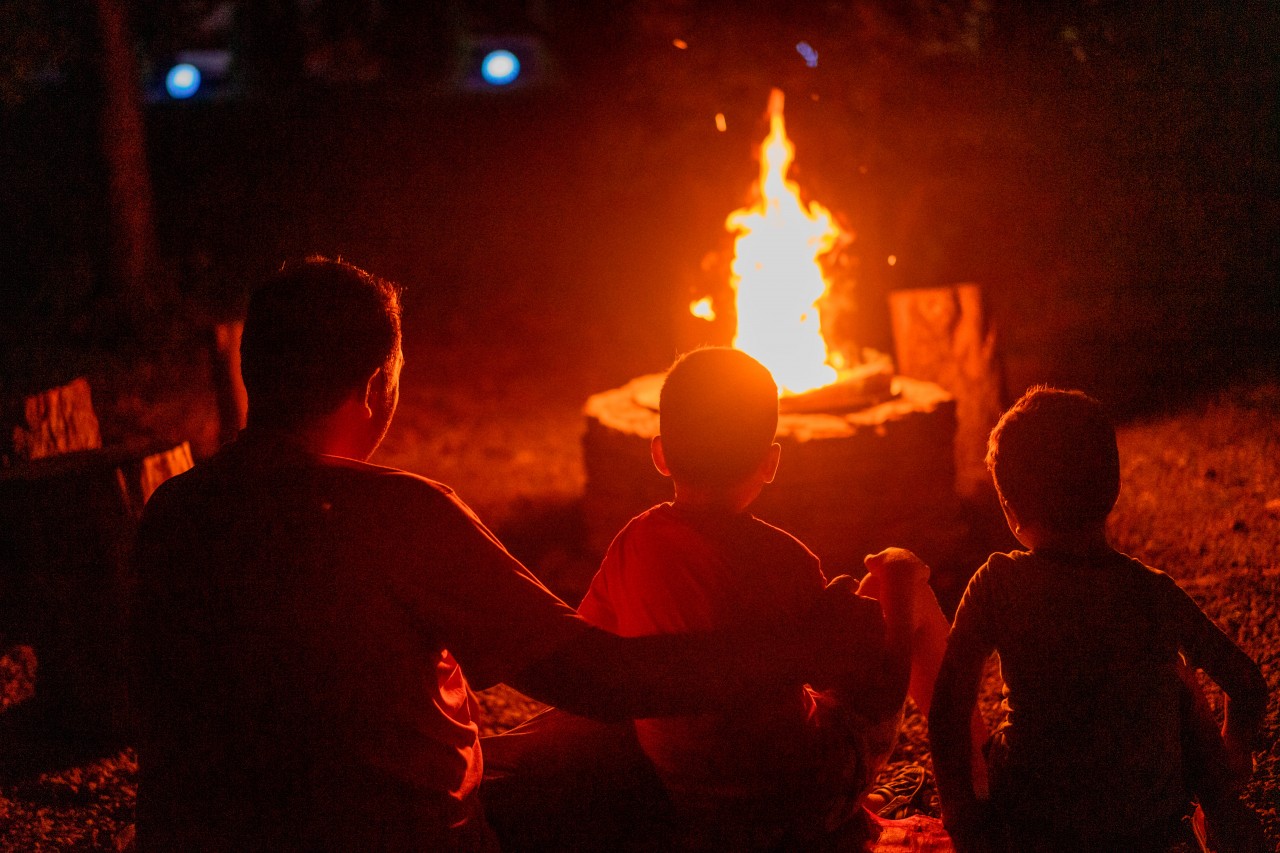 People sitting around bonfire