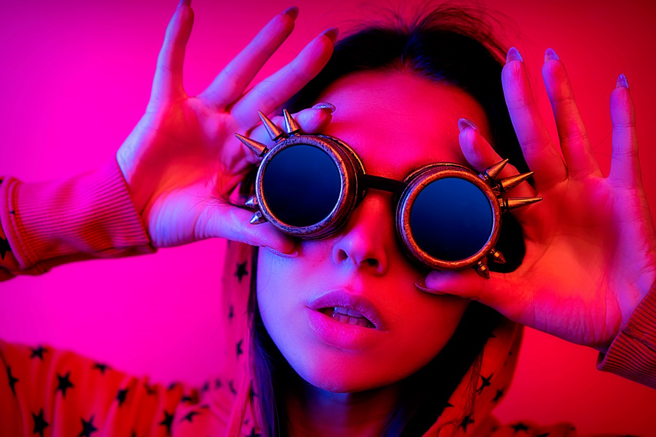 Cyberpunk girl in goggles on a pink background