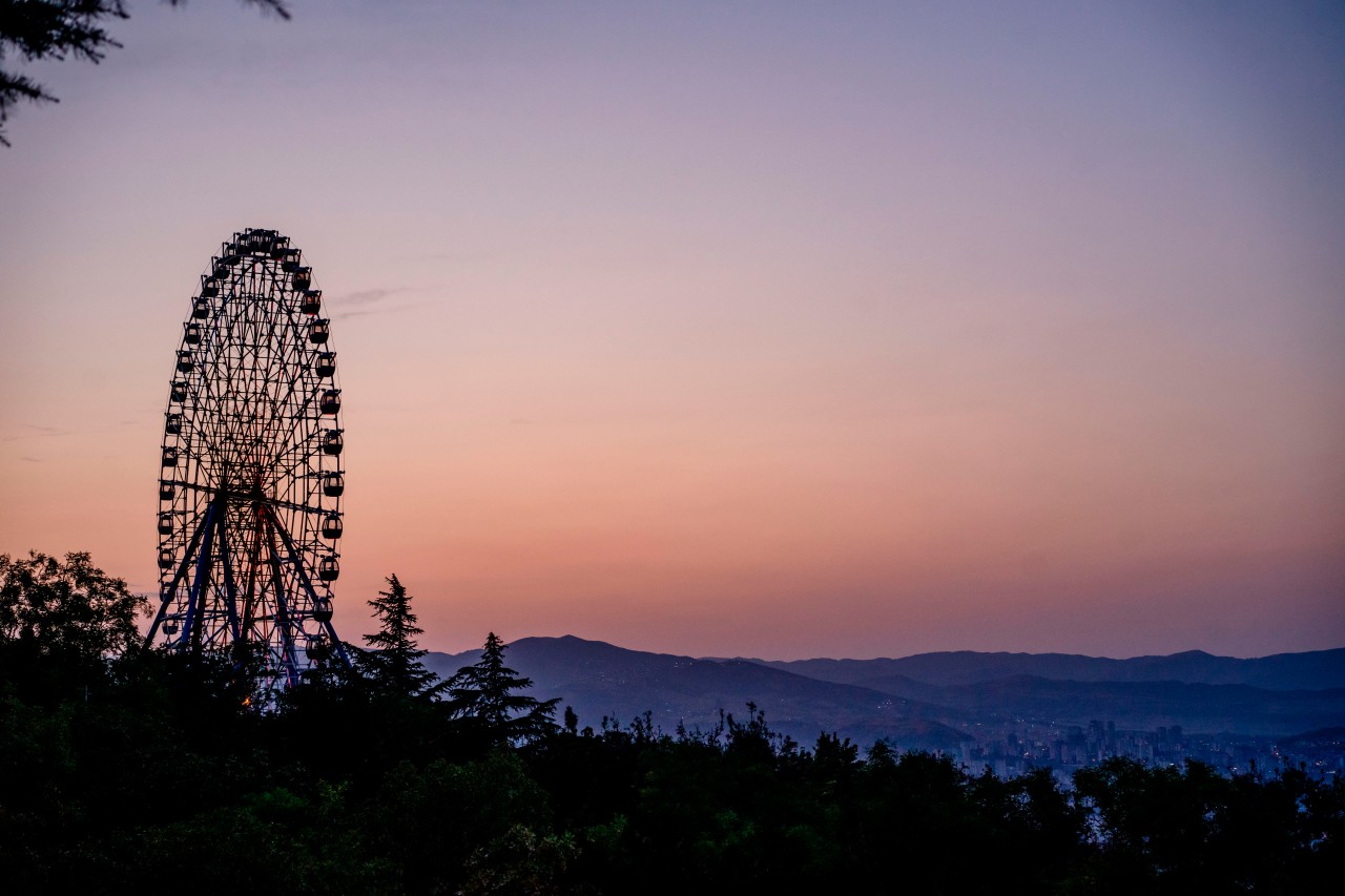 Ferris wheel on the sunset background