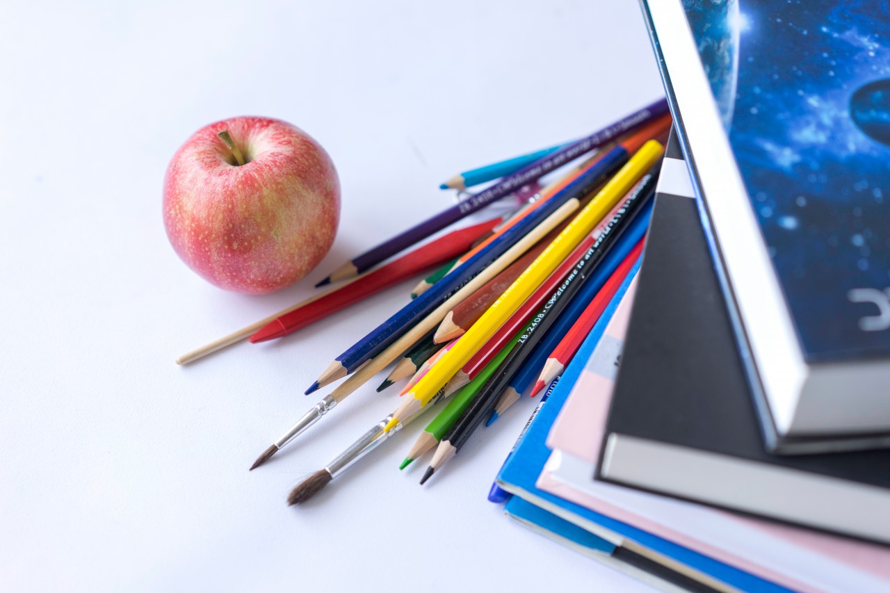 School stationery and apple