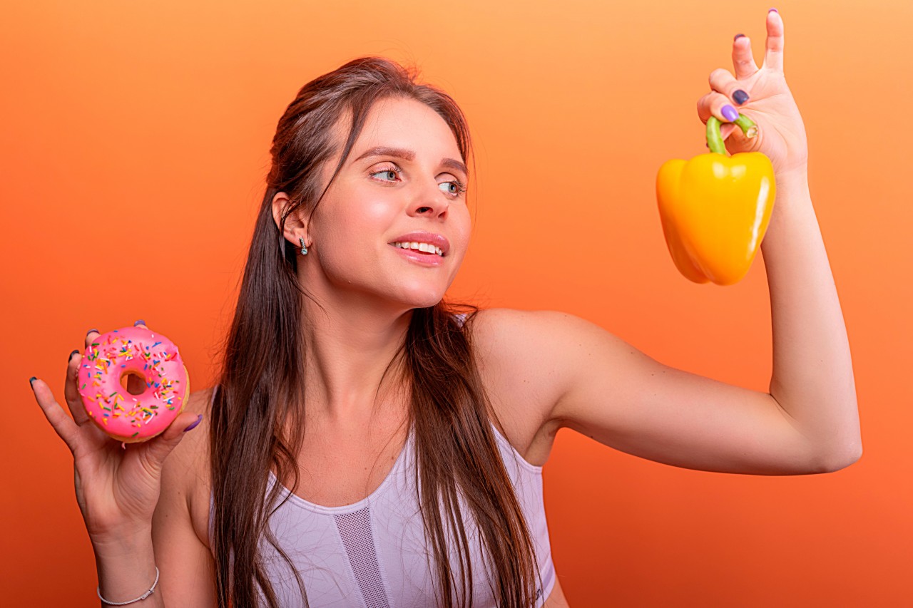 Fitness Girl with Yellow Pepper in Hand