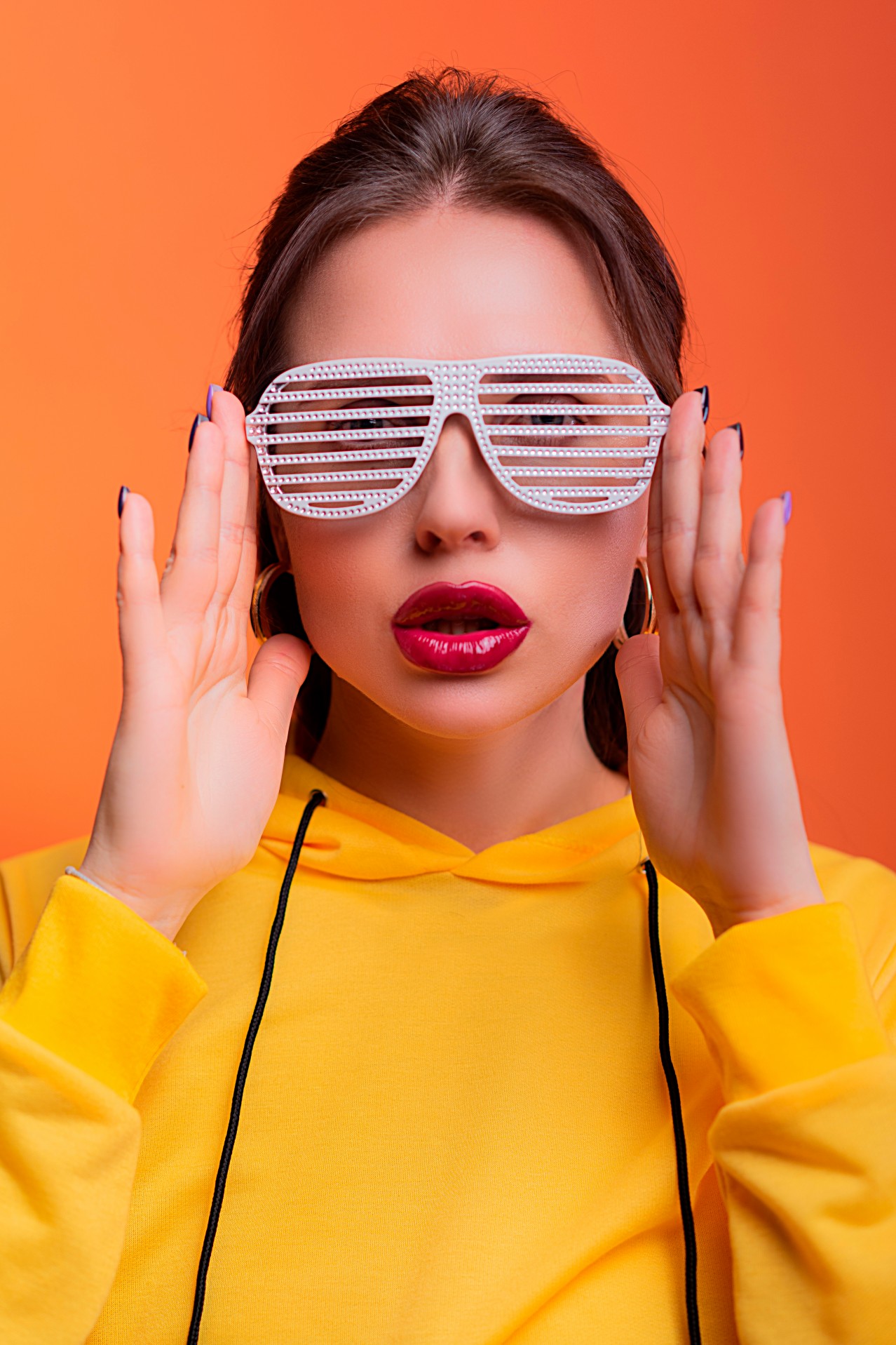 Young Woman with Red Lips on an Orange Background