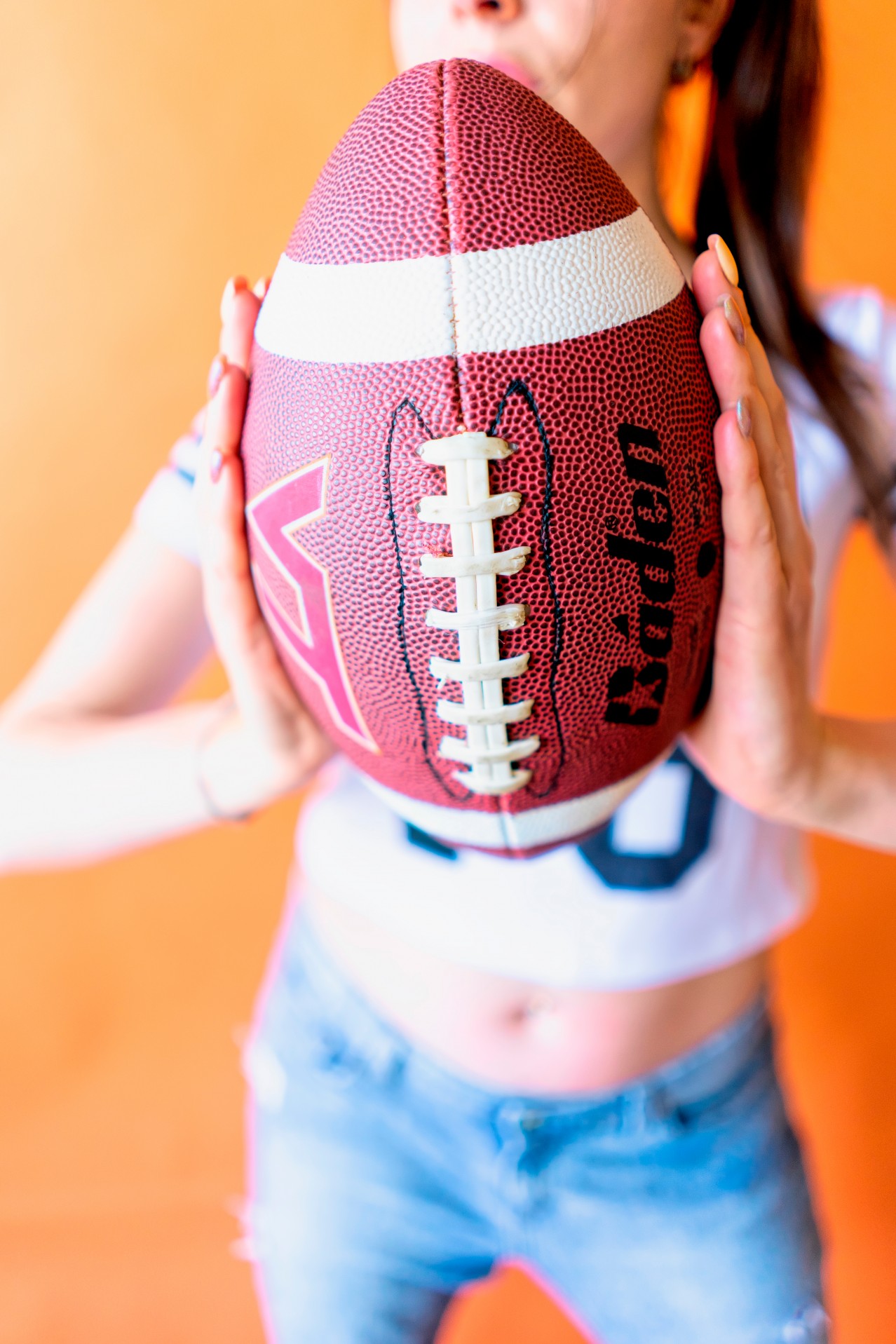 Cropped view of a woman with football ball