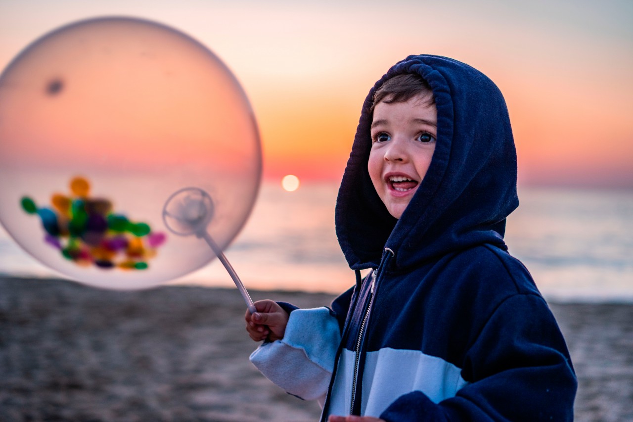 Excited kid with balloon at the beach