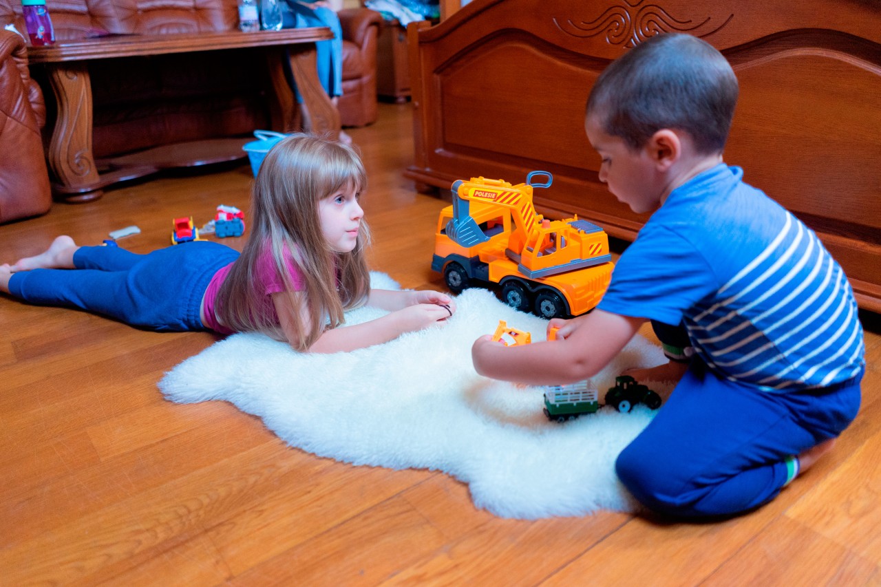 Children play on the white carpet