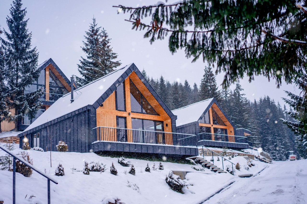 Stylish wooden cottages under the snow