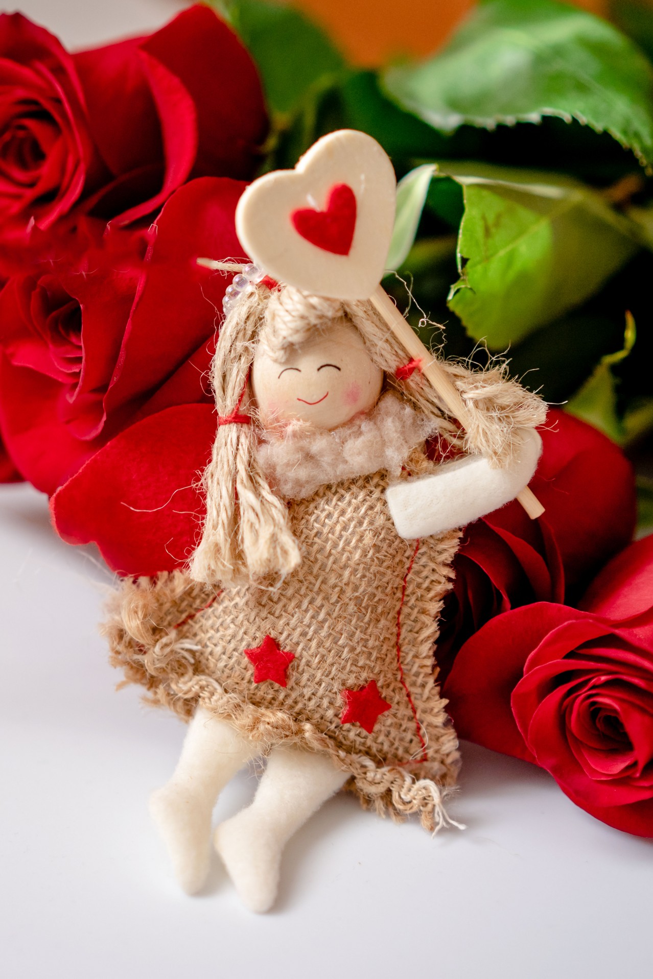A Bouquet of Red Roses with a Decorative Angel