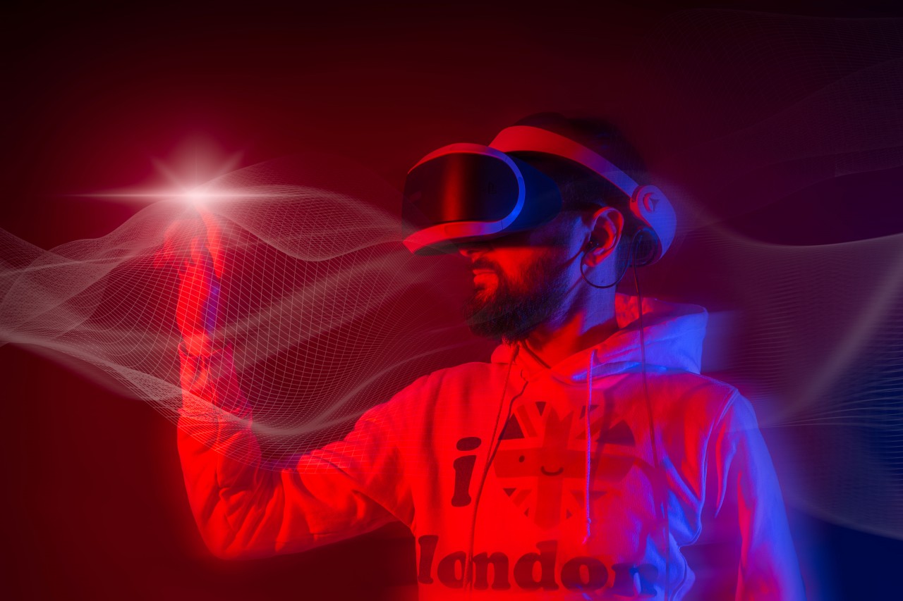 Young Man in Virtual Reality Glasses with a Digital Panel