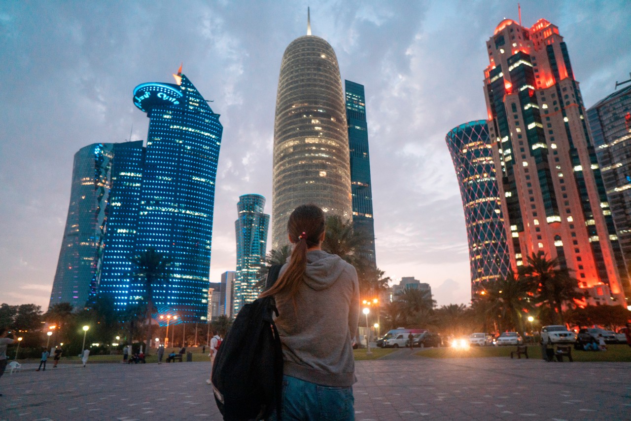Traveling woman looking at skyscrapers