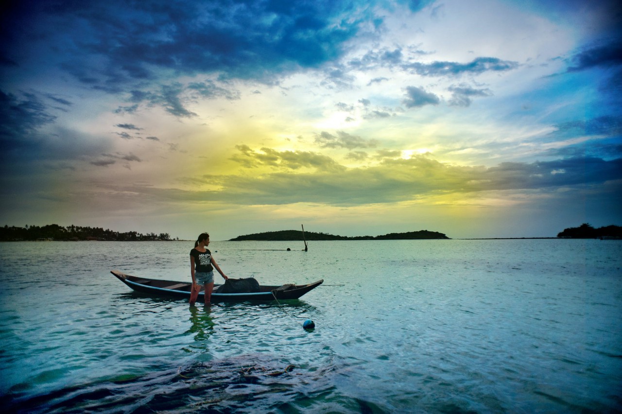 Woman with boat under the beautiful sky